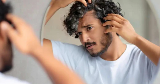 Indian Man looking at grey hair in mirror